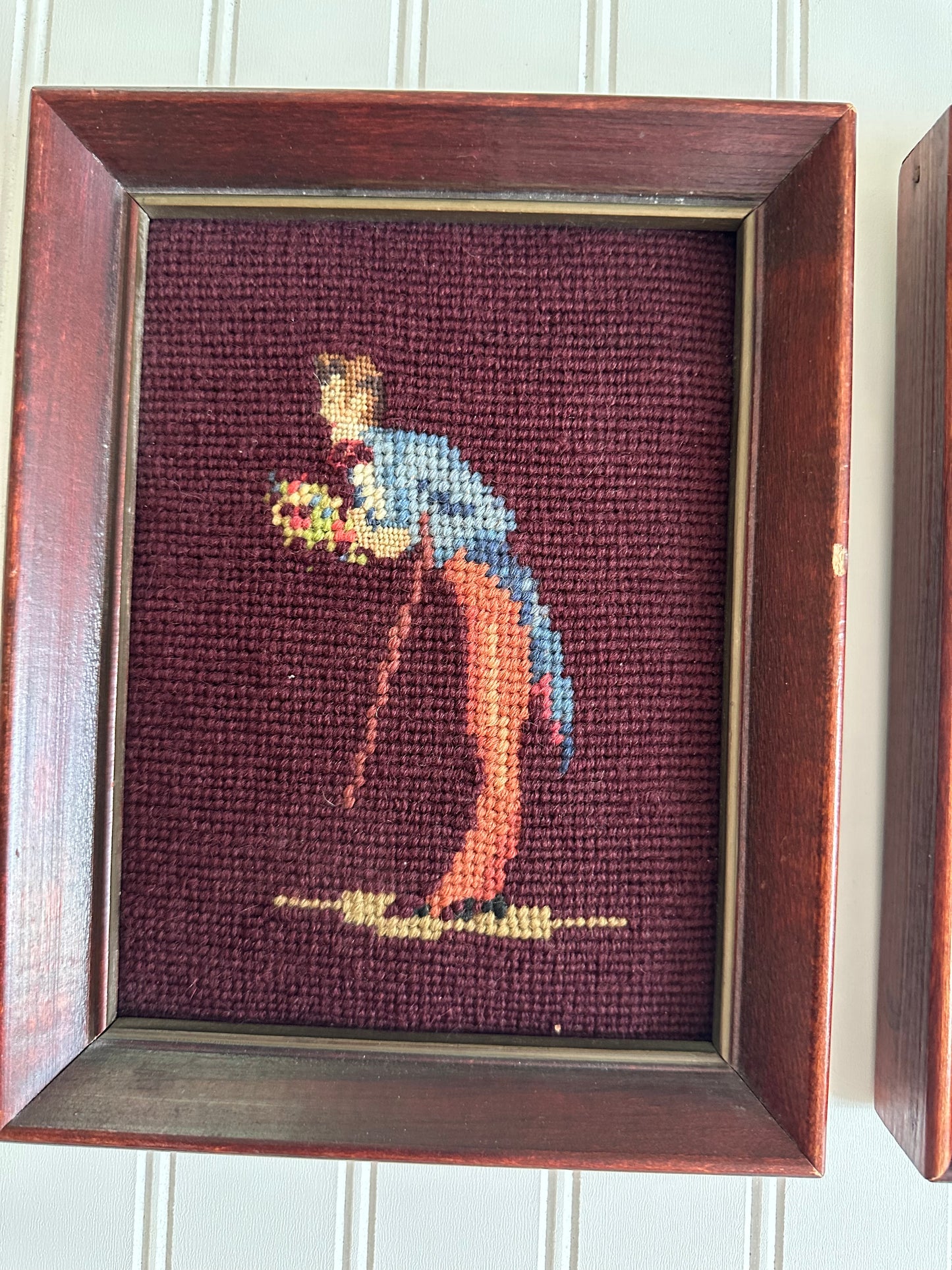 Pair of framed vintage man and woman needlepoints