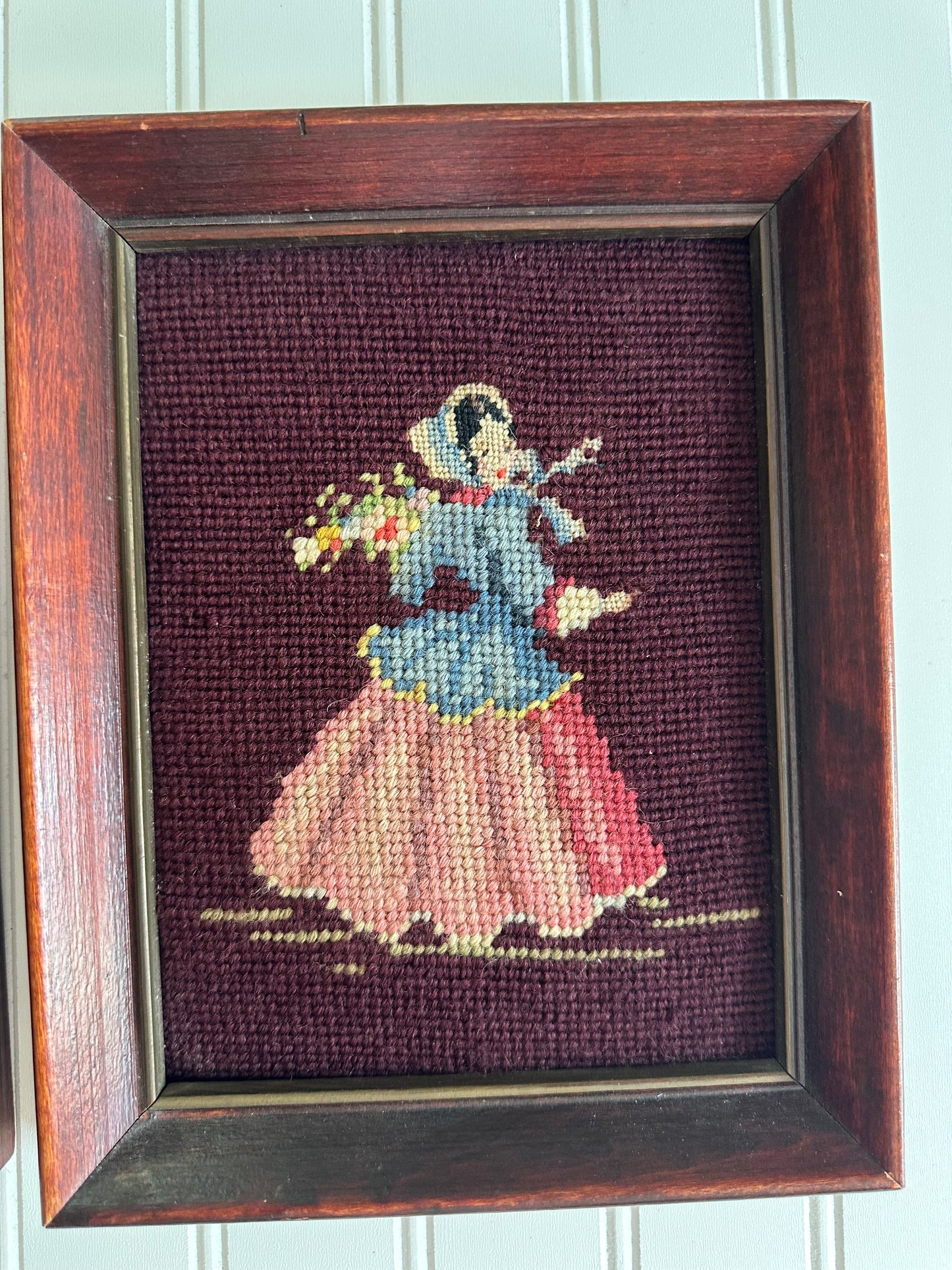 Pair of framed vintage man and woman needlepoints