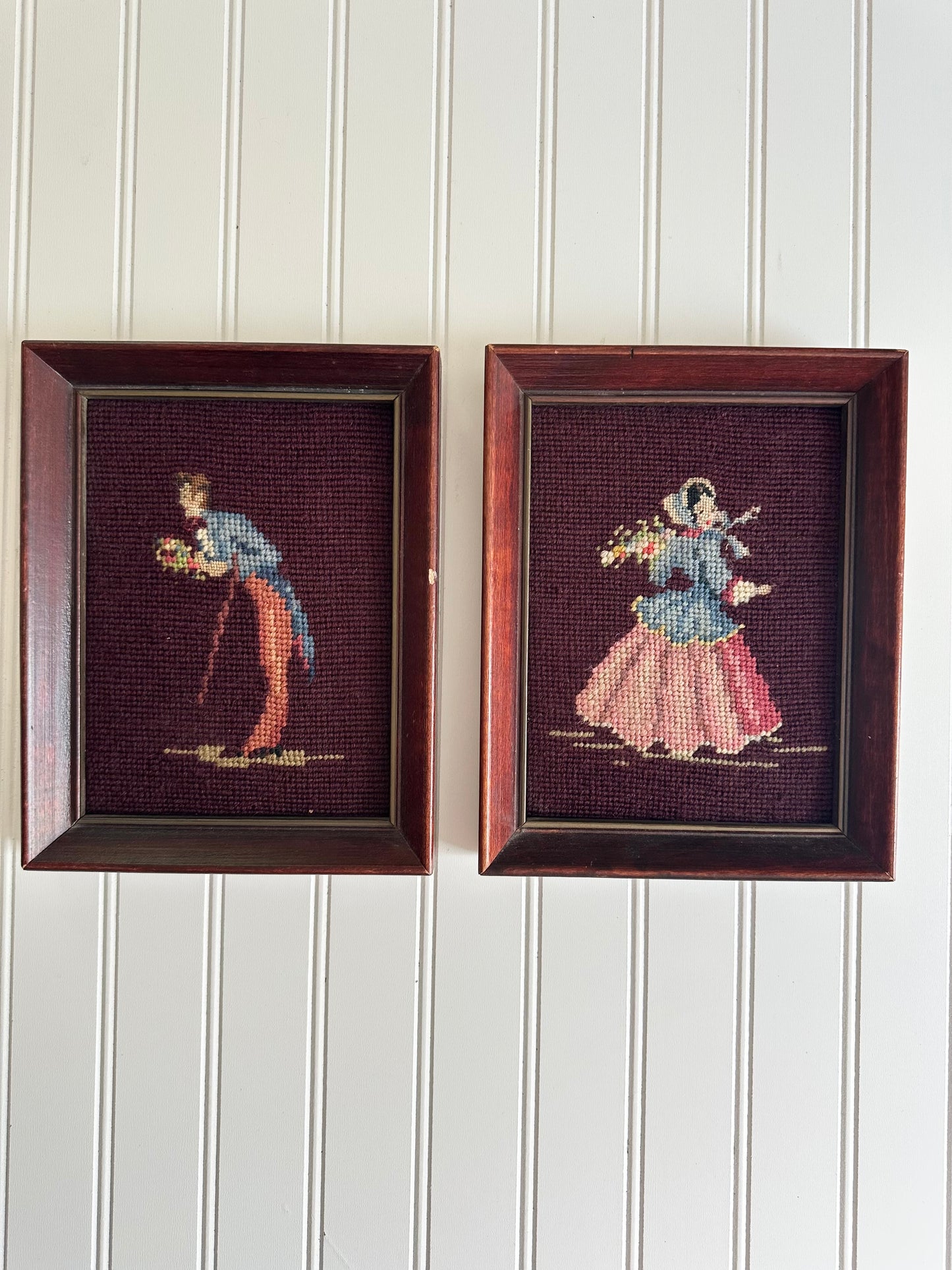 Pair of framed vintage man and woman needlepoints