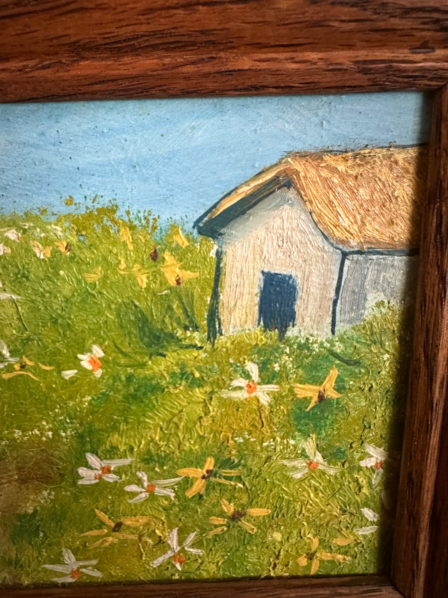 Framed field and cottage painting